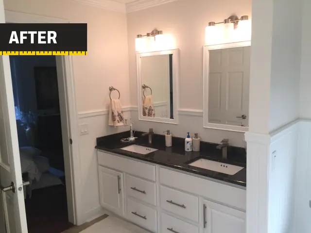 A bathroom we remodeled: double vanity with white cabinets, wainscoting and two mirrors