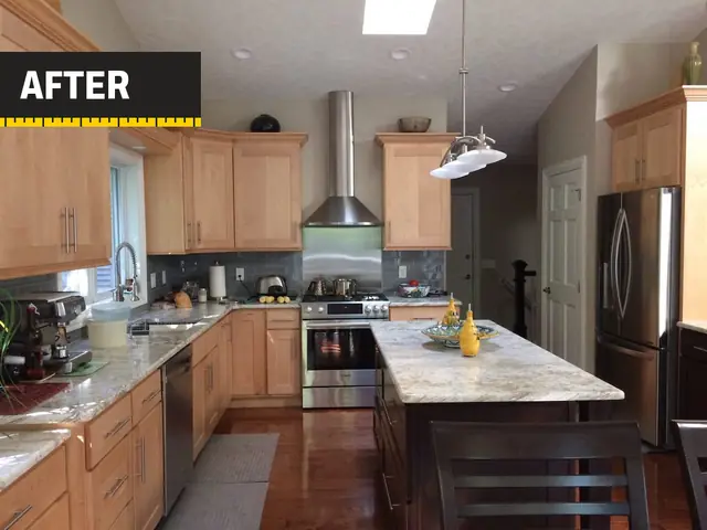 A kitchen we remodeled: maple cabinets to the ceiling, granite island and a stainless range hood