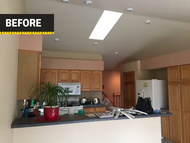 Kitchen before the remodel: oak cabinets under soffits, laminate counters, a peninsula and white appliances